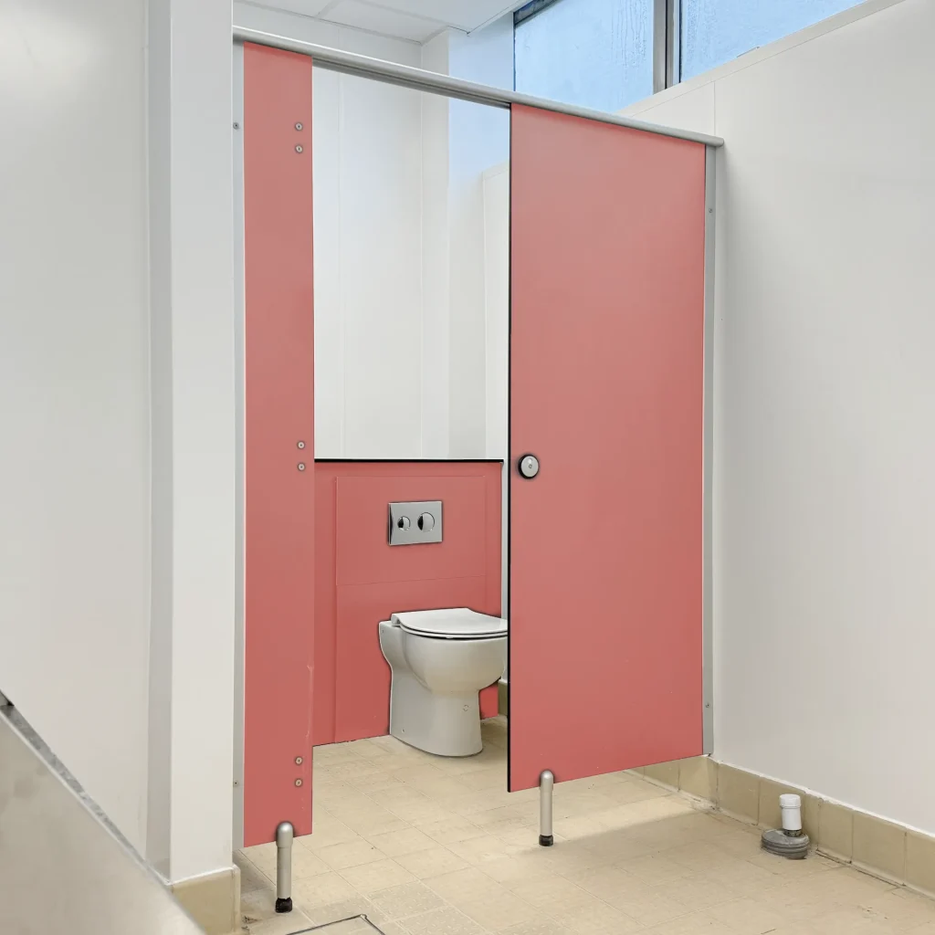 pink washroom cubicle in a leisure facility bathroom