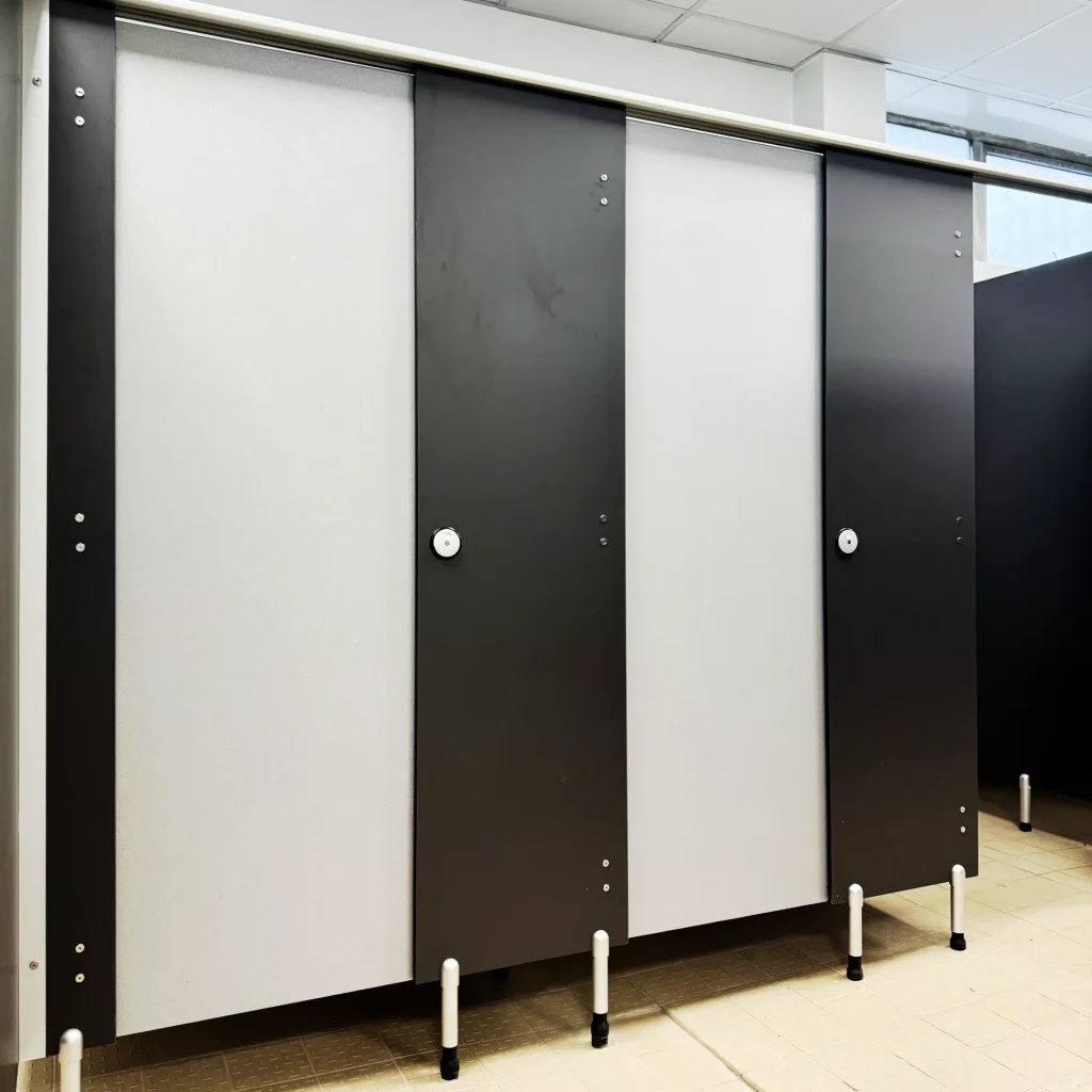 Black and grey washroom cubicles in a leisure facility changing room